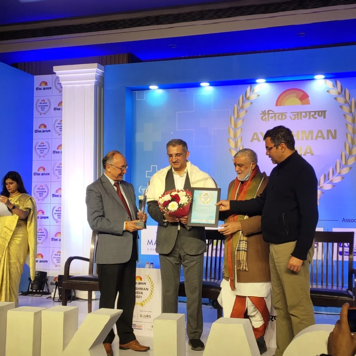 Dr. Sanjeev Bisla receiving the Ayushman Bharat Award from Dainik Jagran