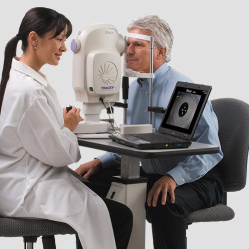 “iTrace Visual Function Analyzer in Use for Comprehensive Eye Examination” Eye care professional conducting a diagnostic test using the iTrace Visual Function Analyzer on a male patient.